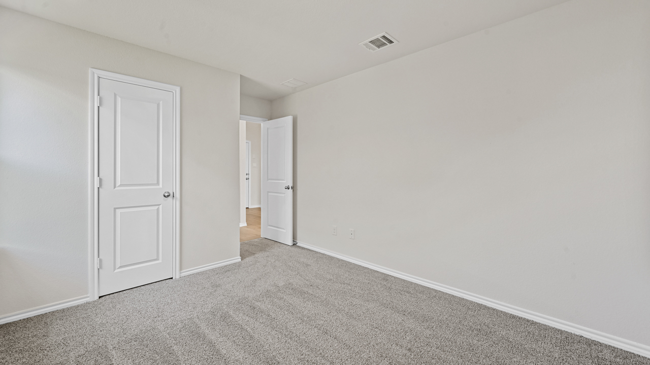 an empty bedroom with gray floors and white walls