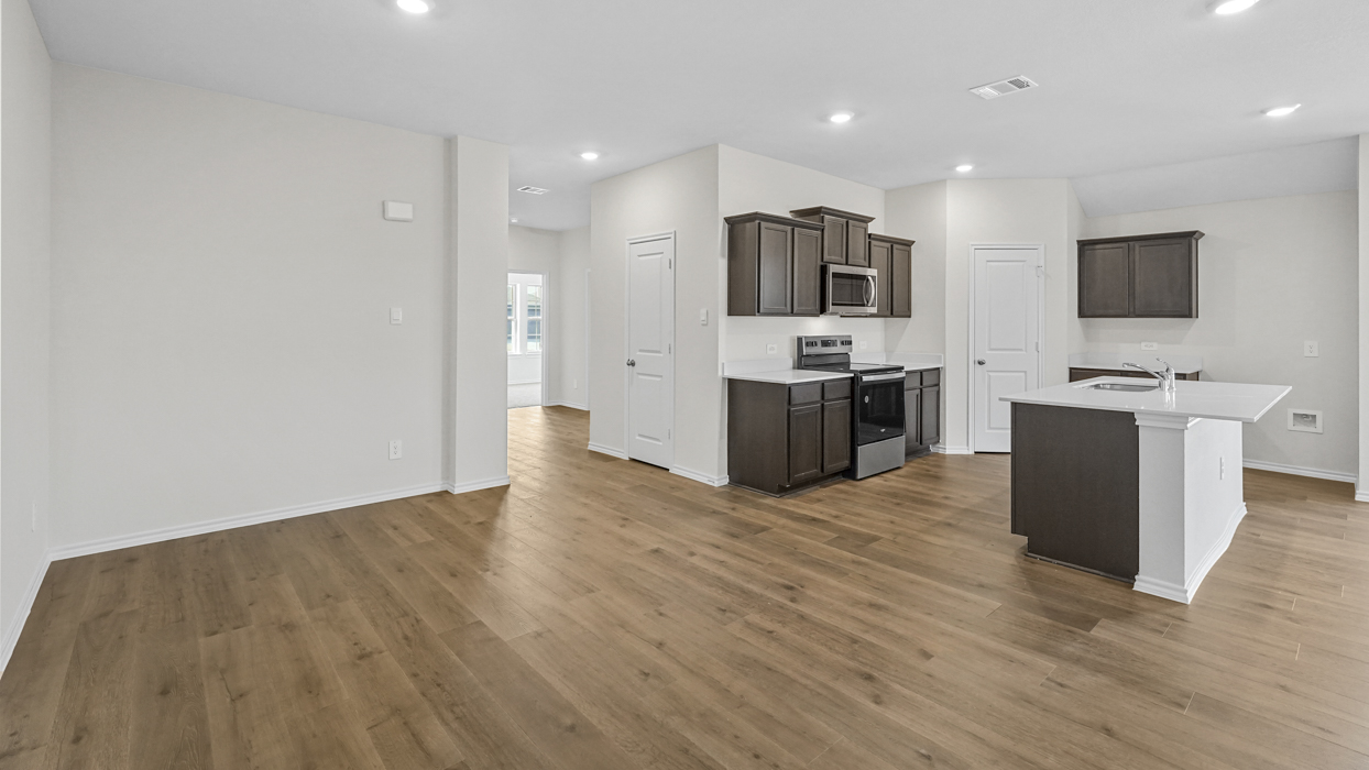 a kitchen with dark cabinets and an island in the middle with white counter tops