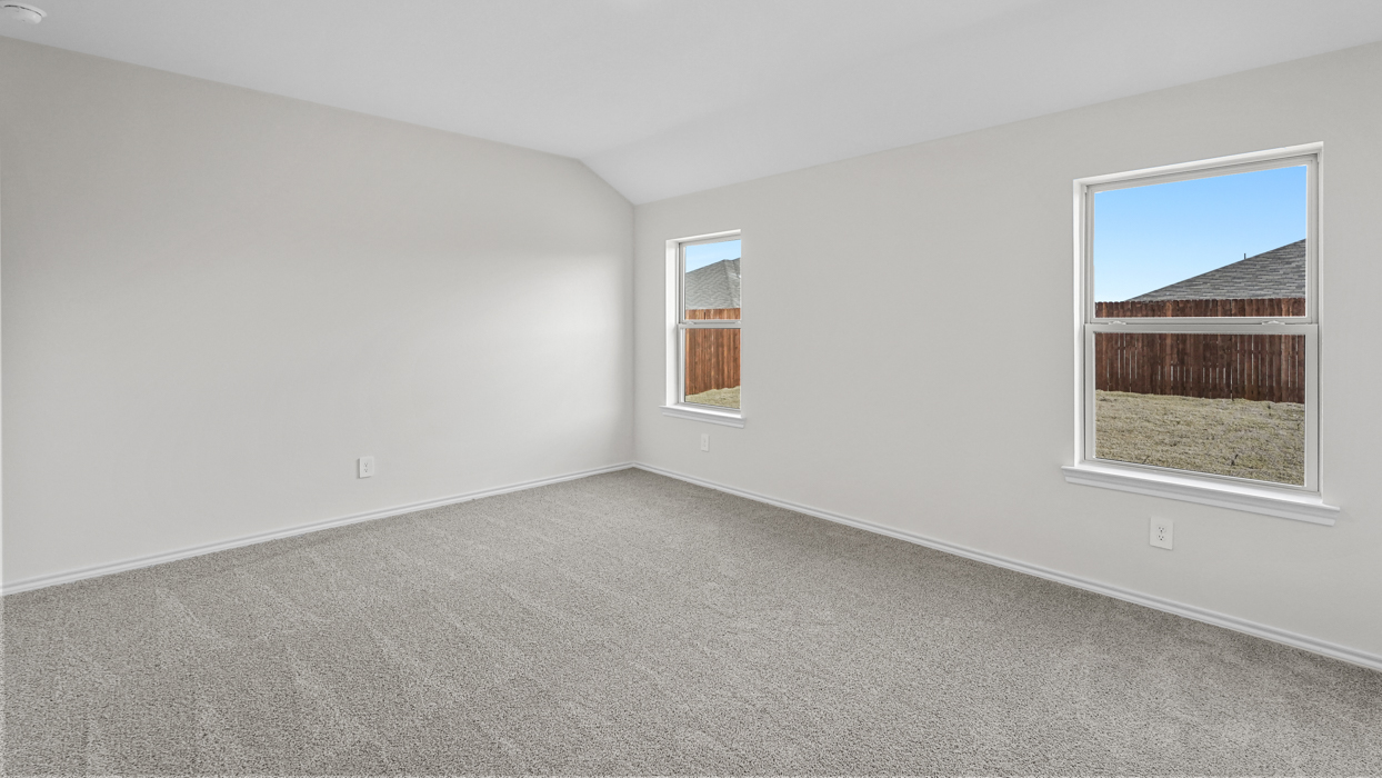an empty bedroom with gray carpet and white walls
