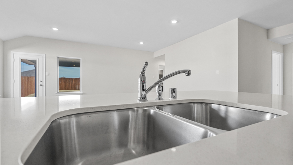 a kitchen with dark cabinets and an island in the middle with white counter tops