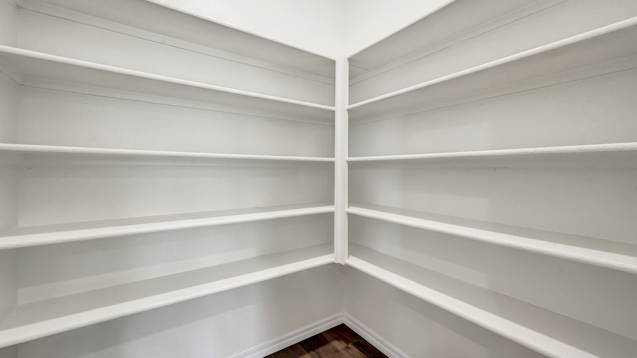 the pantry in a kitchen with built in shelves