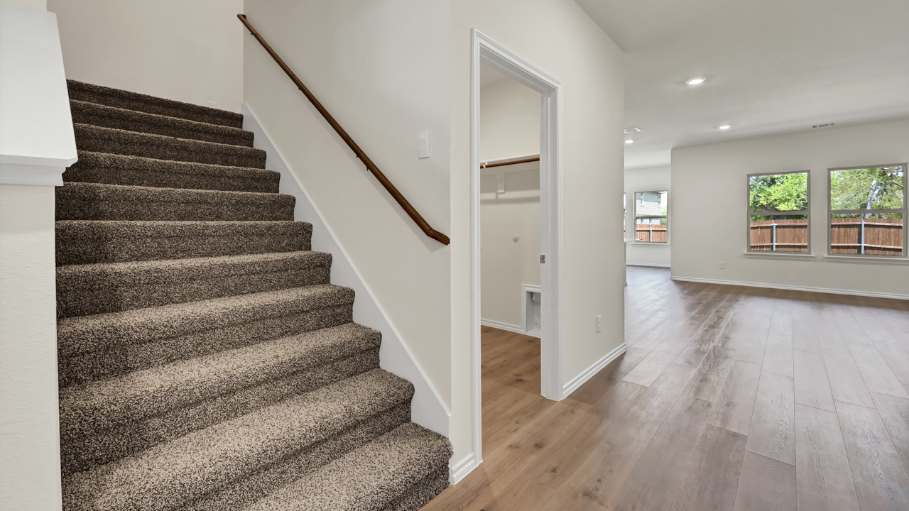 the stairs to a home with carpet