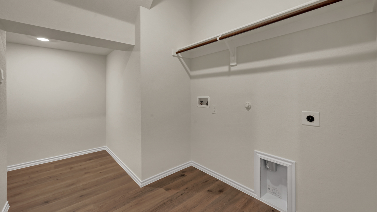 an empty utility room with shelves for hanging clothes