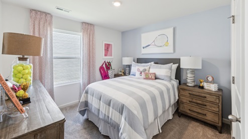 Bedroom with window, bed, dresser and brown bedside table