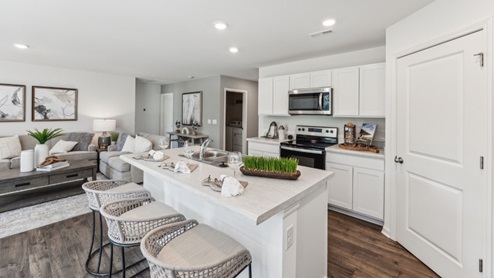 Kitchen island with barstools and white cabinetry