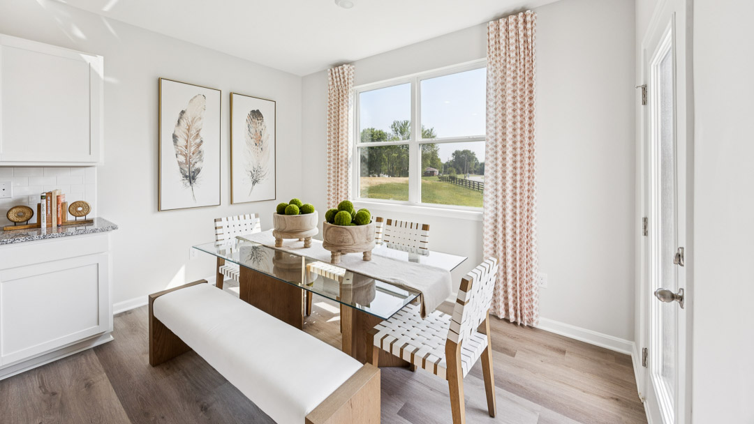 Dining area with rectangular table, back door, and double window facing backyard