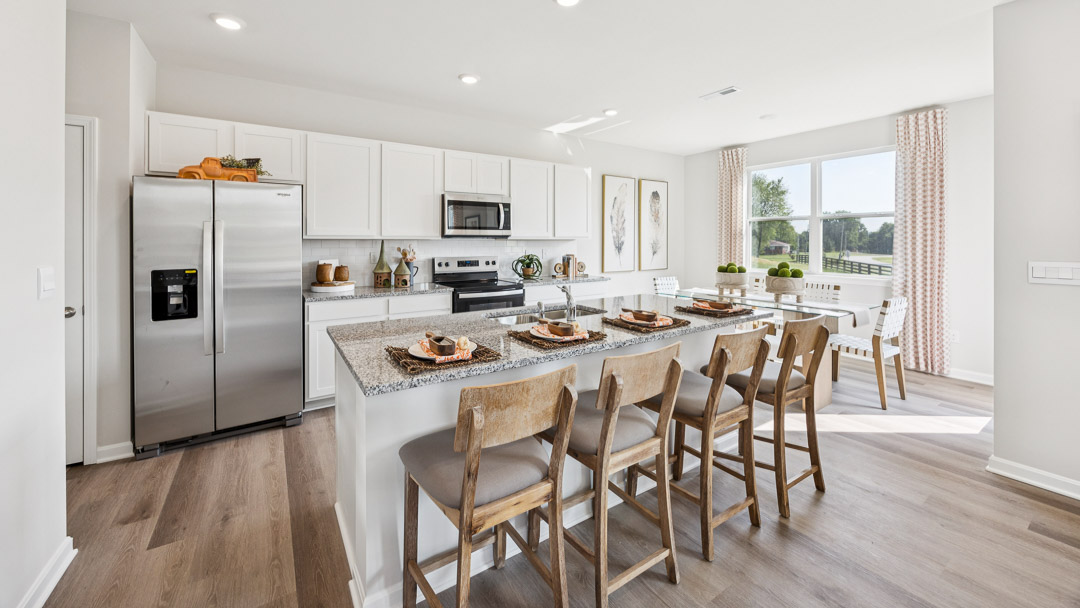 Spacious kitchen with white cabinets and center island.