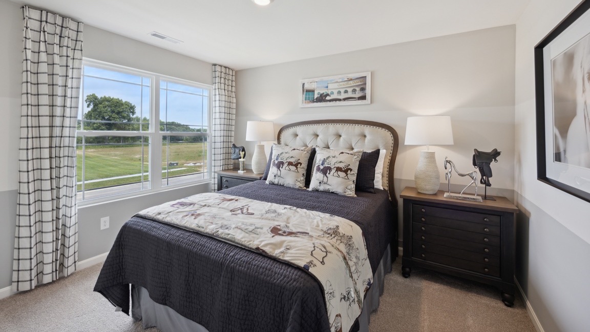Upstairs spare bedroom with double window, bed, and 2 nightstands.