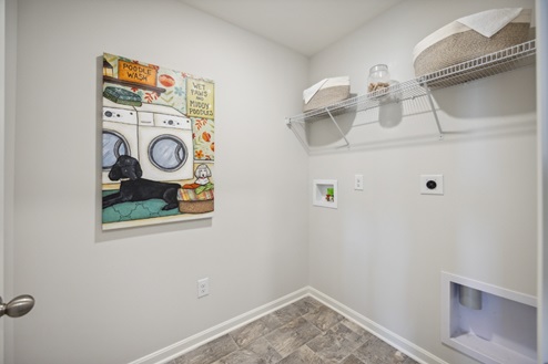 Laundry room, white walls, white wire shelving, vinyl flooring