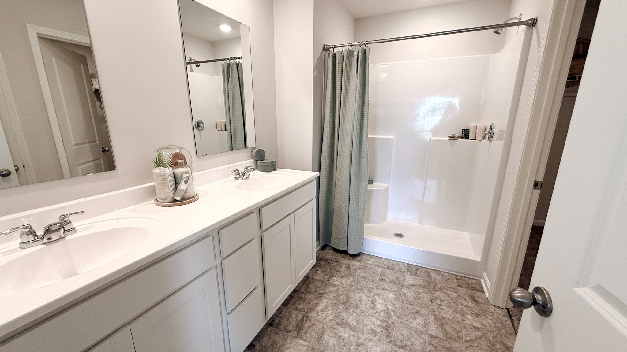 Primary ensuite bathroom with a double bowl vanity and walk-in shower.