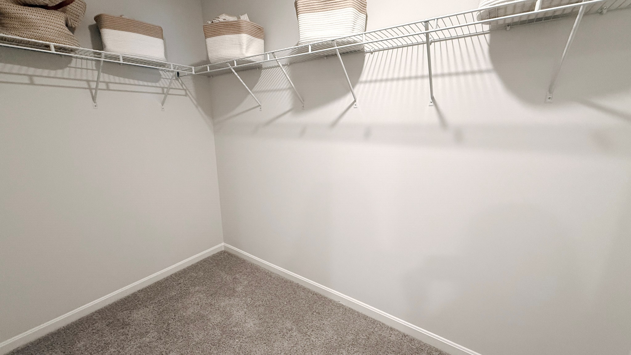Primary walk-in closet with wire shelving.