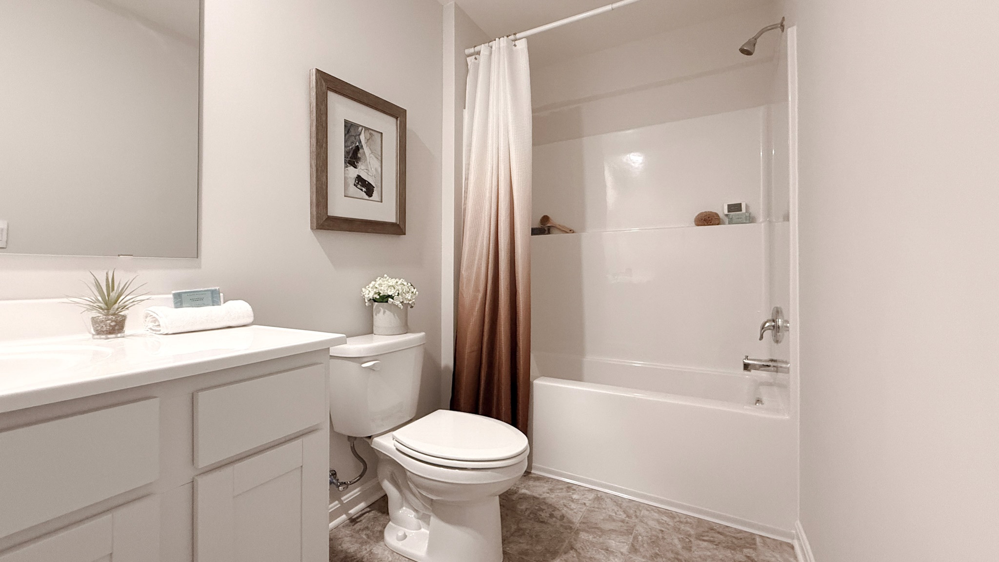 Spare bathroom with vanity, commode, and shower/tub combo.