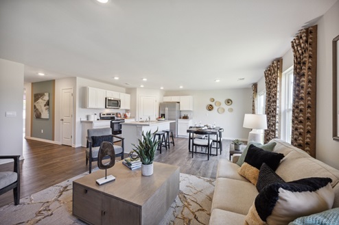 Open concept living space, view from living room into casual dining area and kitchen