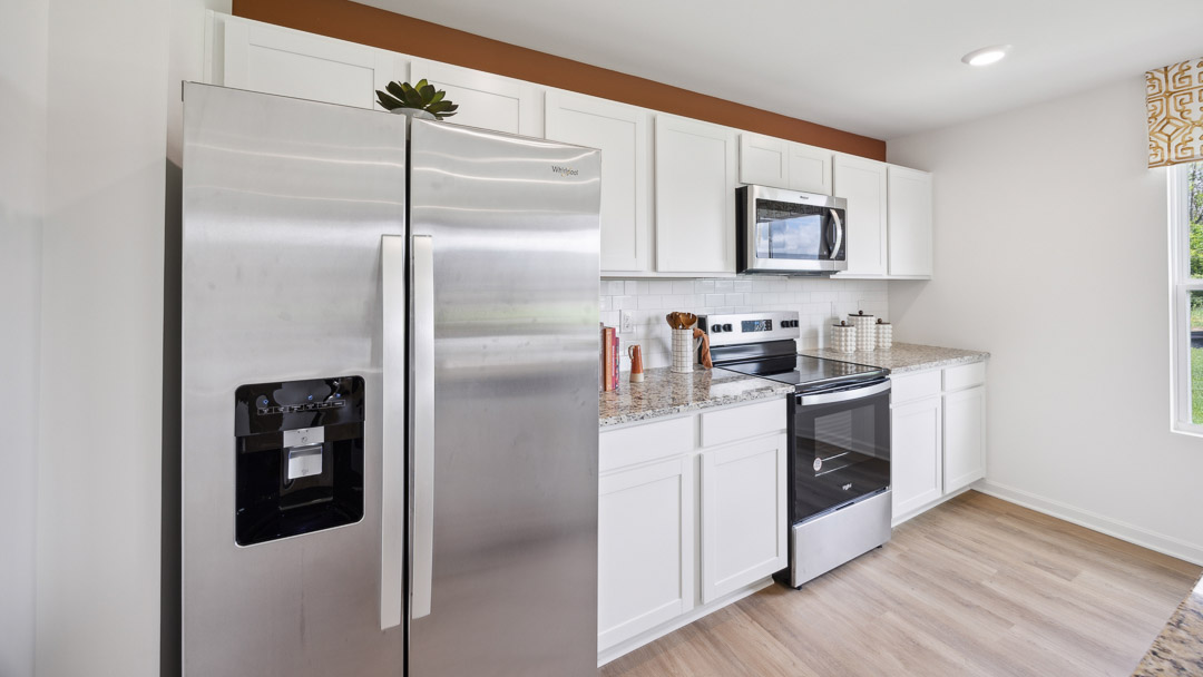 Other view of kitchen cabinets with stainless-steel appliances.