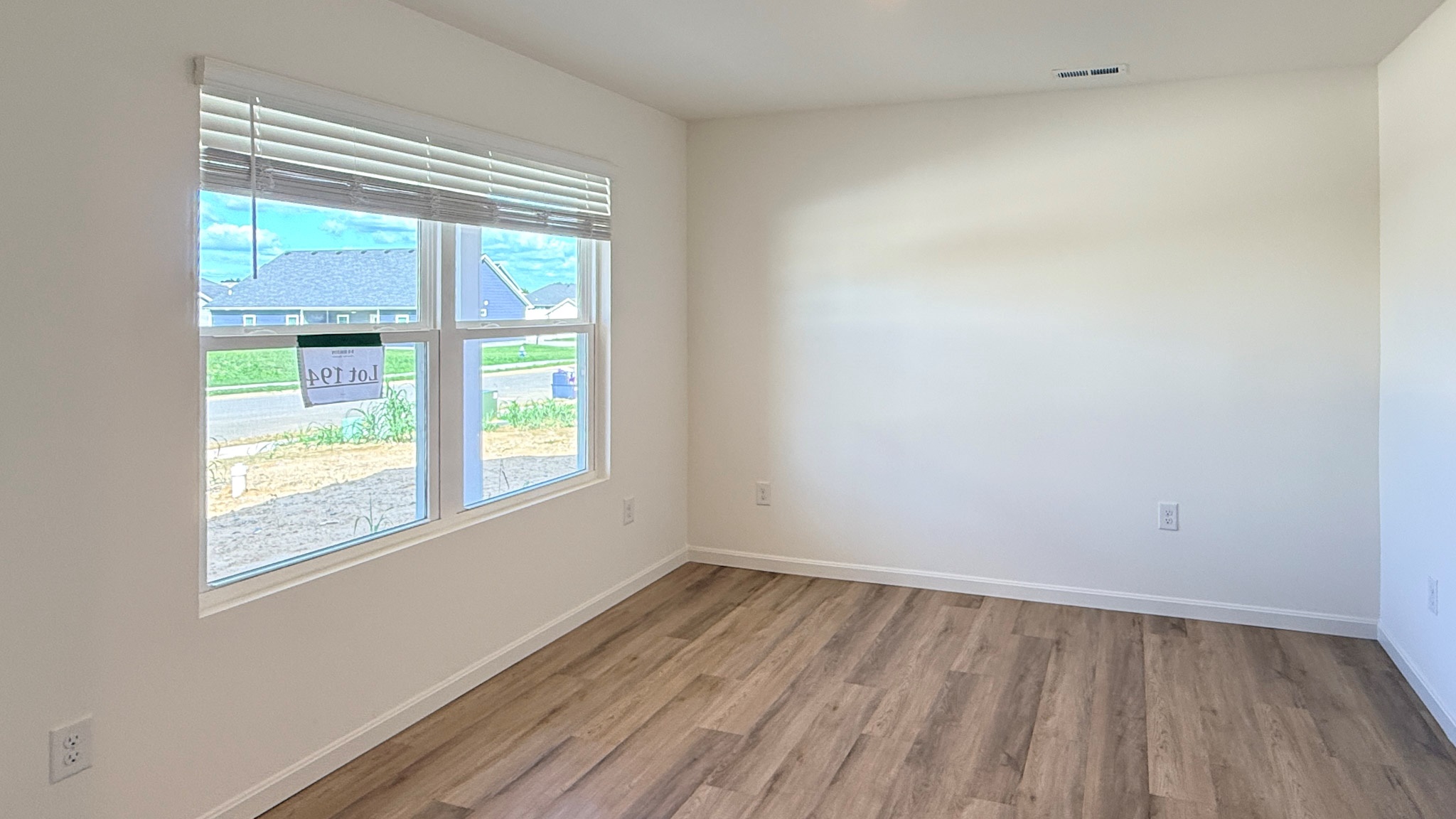 First floor flex room with double window and LVP flooring.