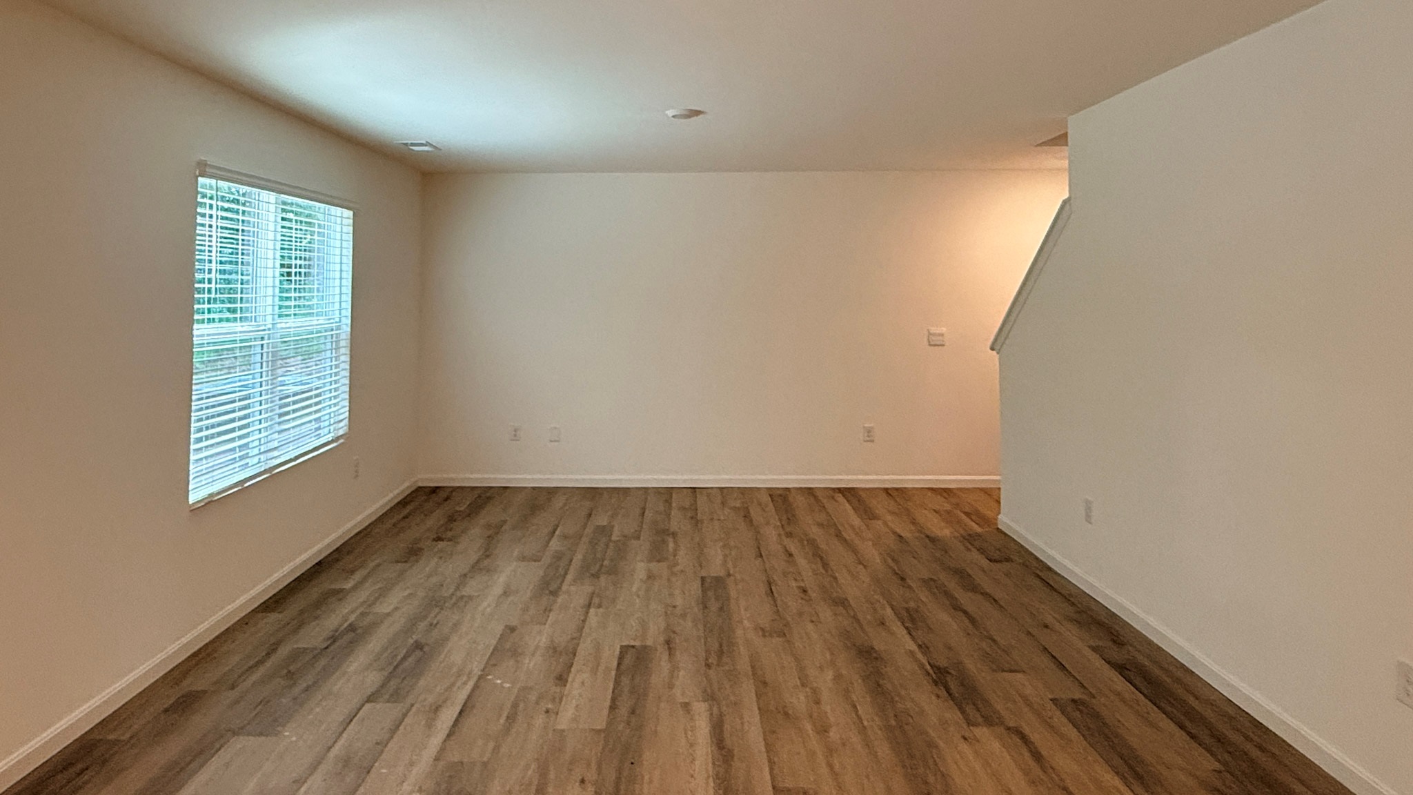 Living room with double window and LVP flooring.
