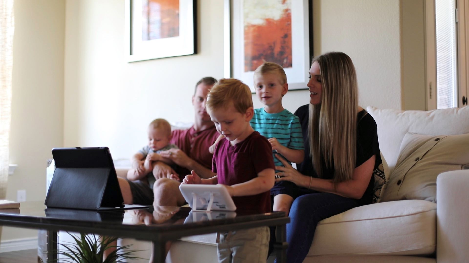 Family gathered around looking at smart home display.