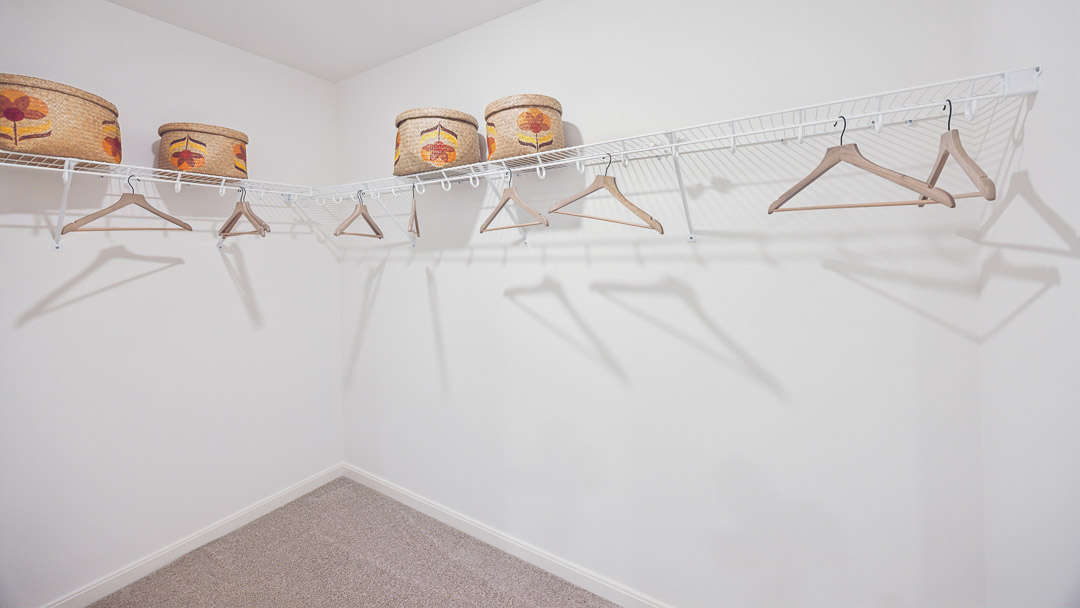 Walk-in closet with wire shelving.