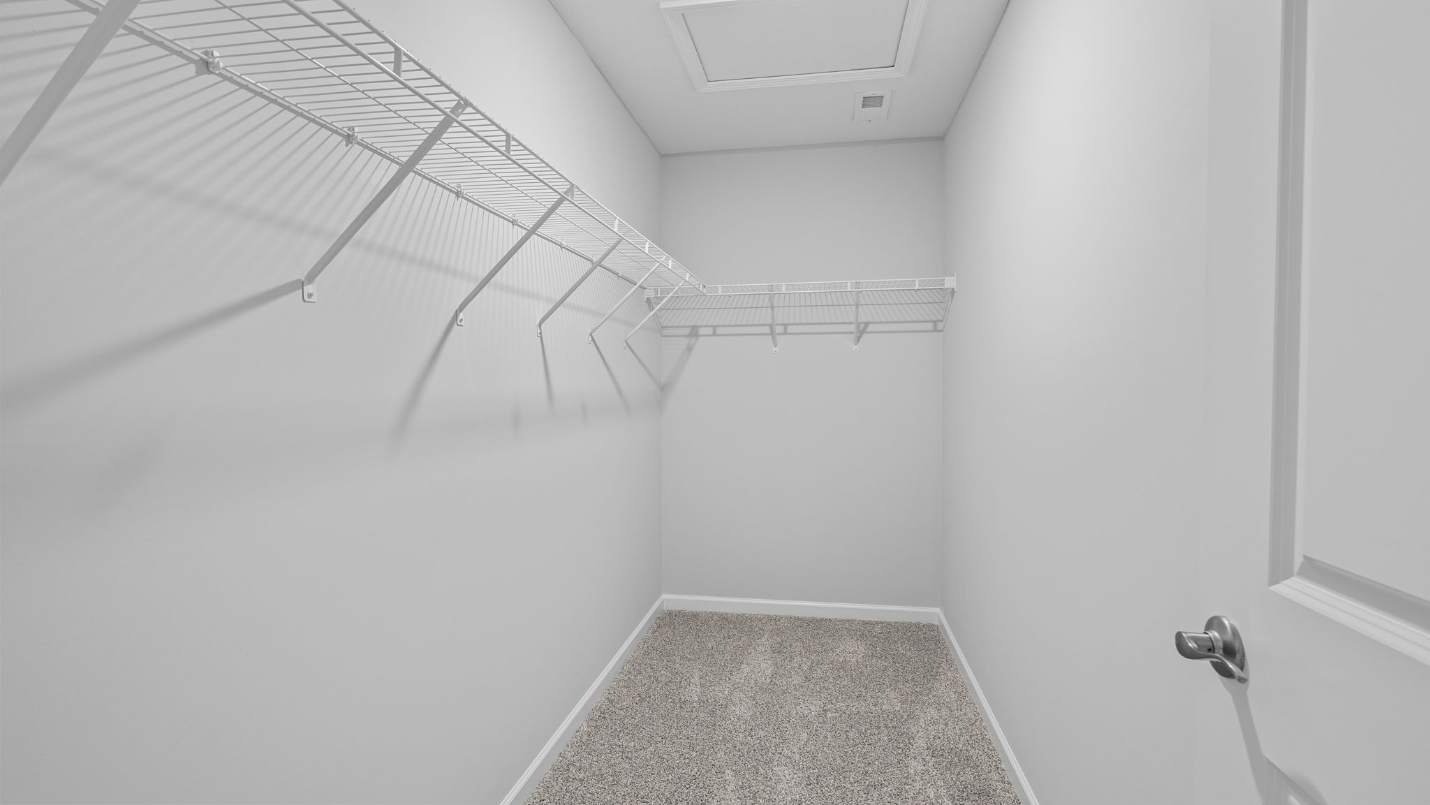 Primary walk-in closet with wire shelving.
