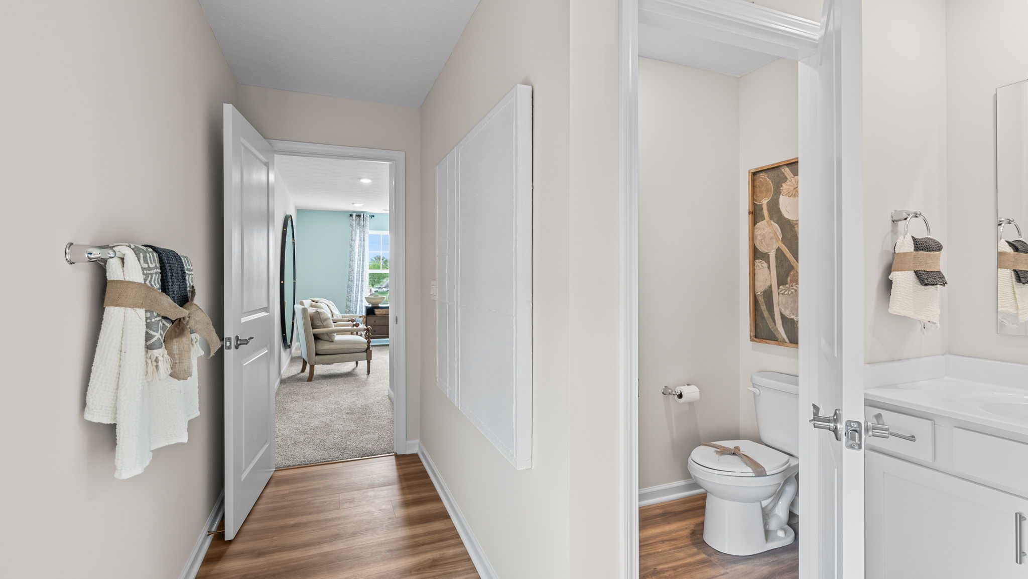Other view of primary bathroom looking towards the bathroom entry door and a water closet with commode.