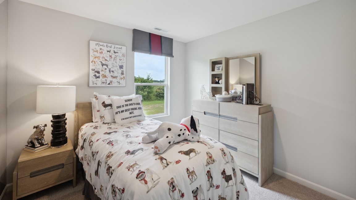 Spare bedroom with bed, nightstand, window, and dresser.