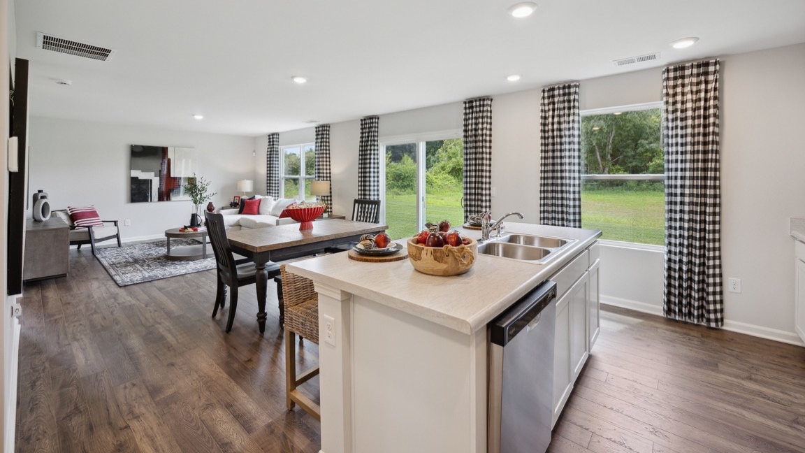 Kitchen island, dining area, and living room