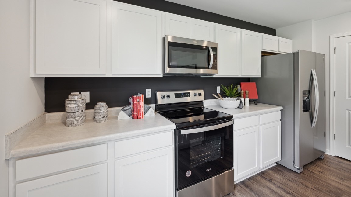 Kitchen with stainless steel range, overhead microwave, and refrigerator