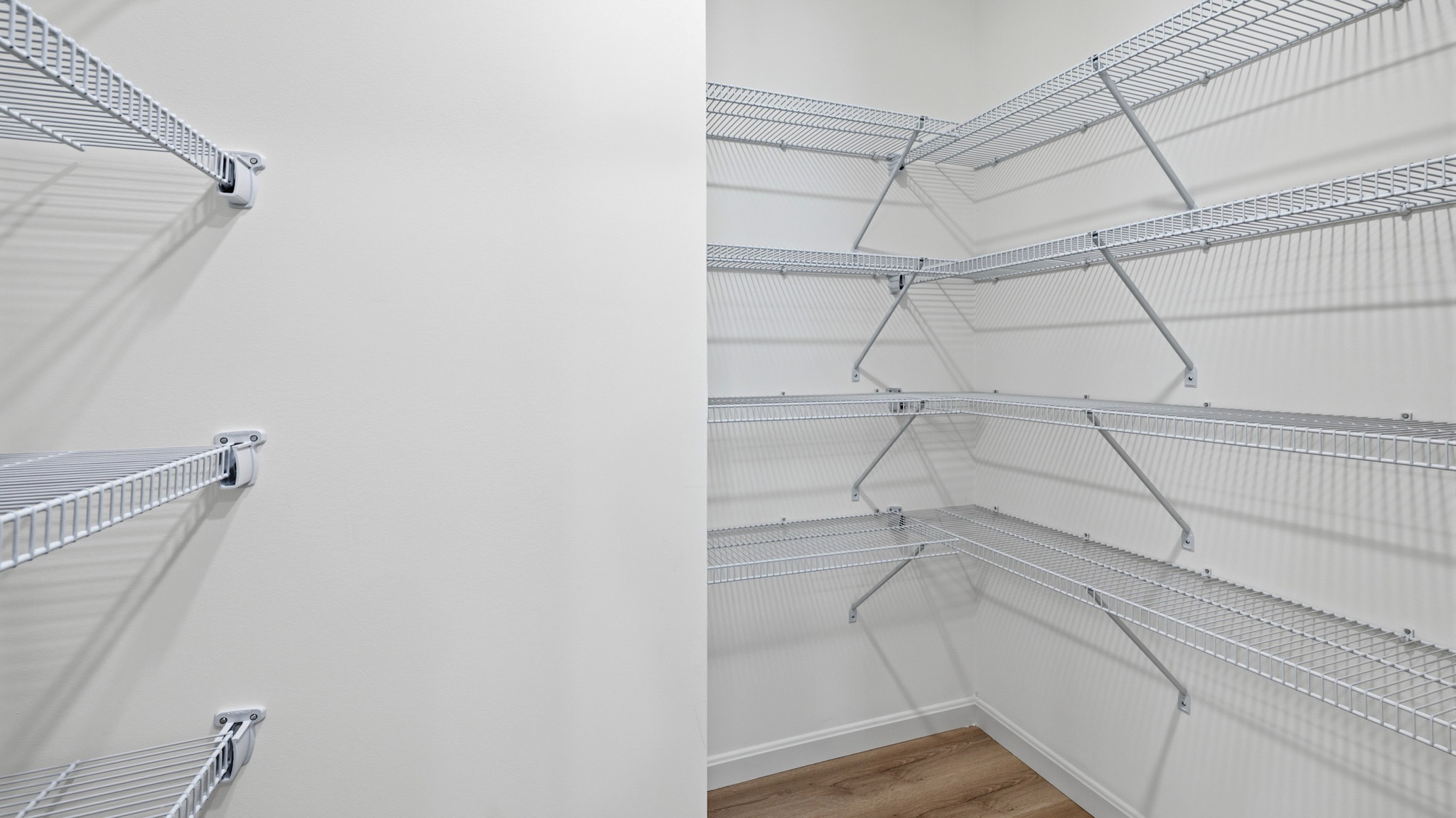 Kitchen walk-in pantry with wire shelving.