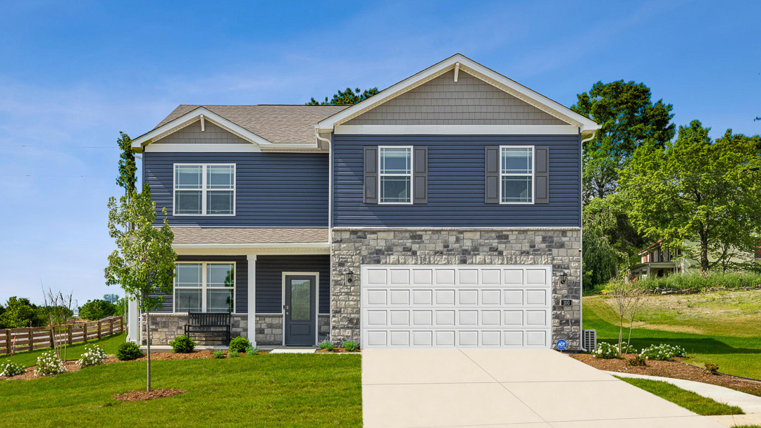 Exterior two-story blue home with stone detailing