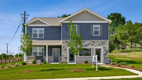 Exterior two-story blue home with stone detailing