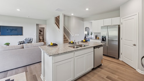 Interior kitchen with center island with white cabinets