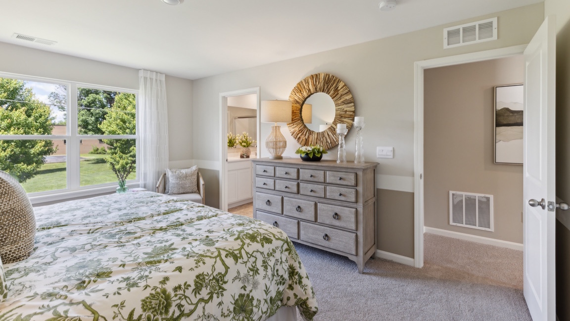 primary bedroom and door to private ensuite bathroom