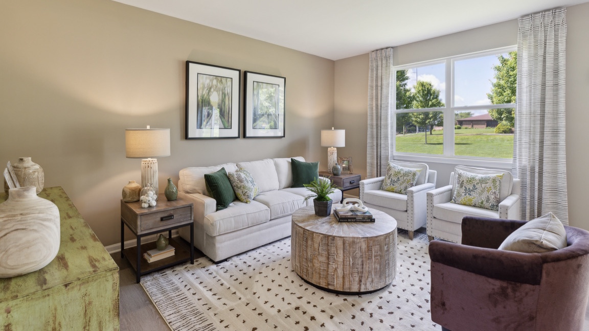 living room with plenty of seating, large double window and accent table