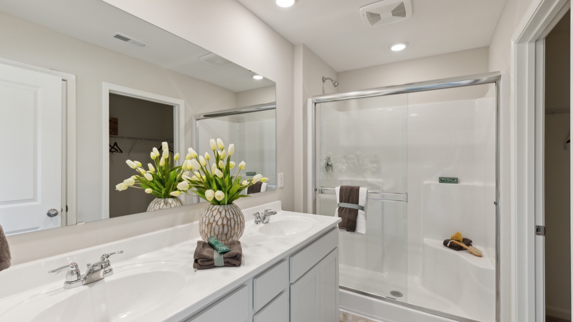 Primary bathroom with double bowl vanity and walk-in shower