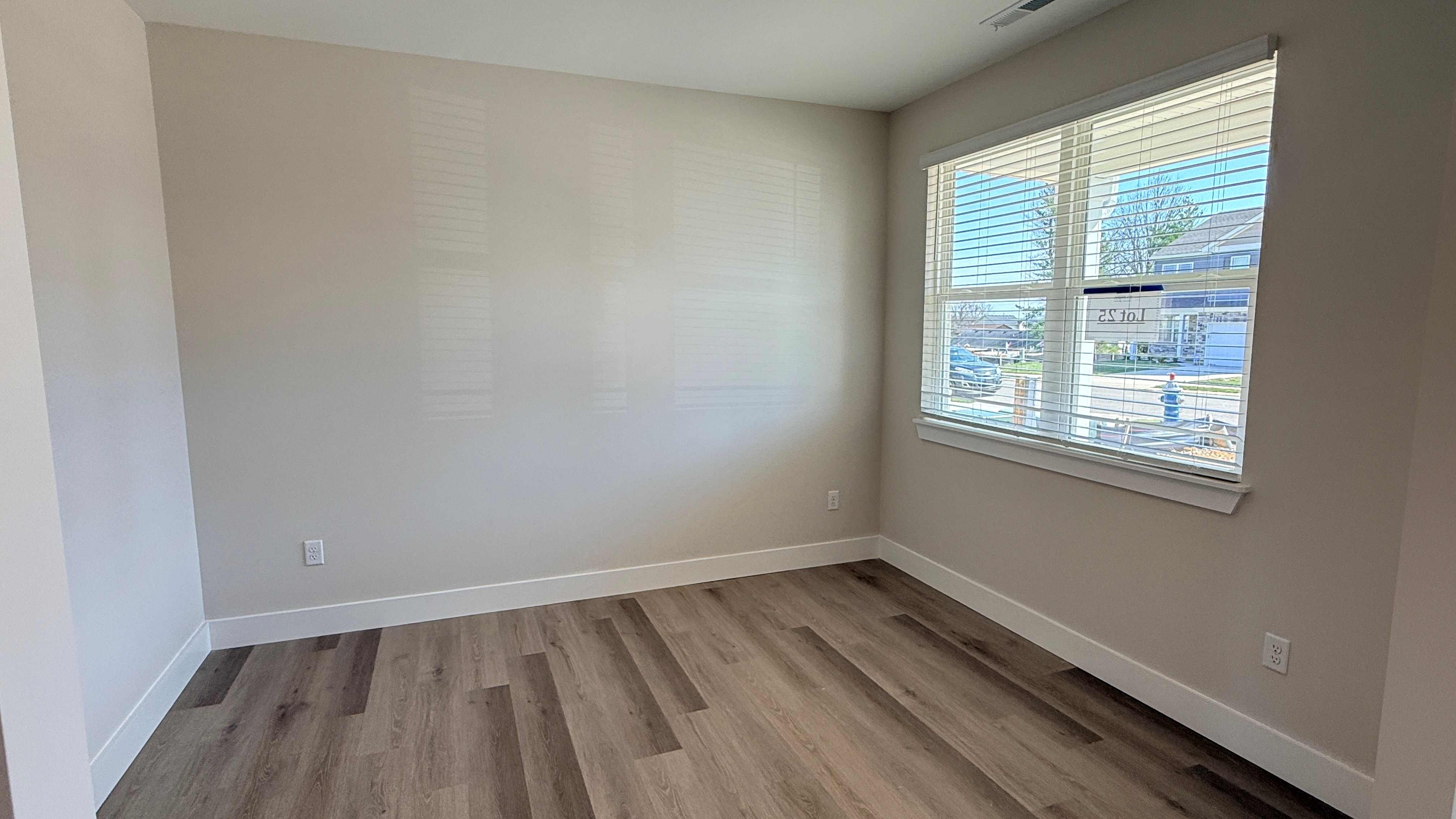 First floor front flex room with double window overlooking front yard.