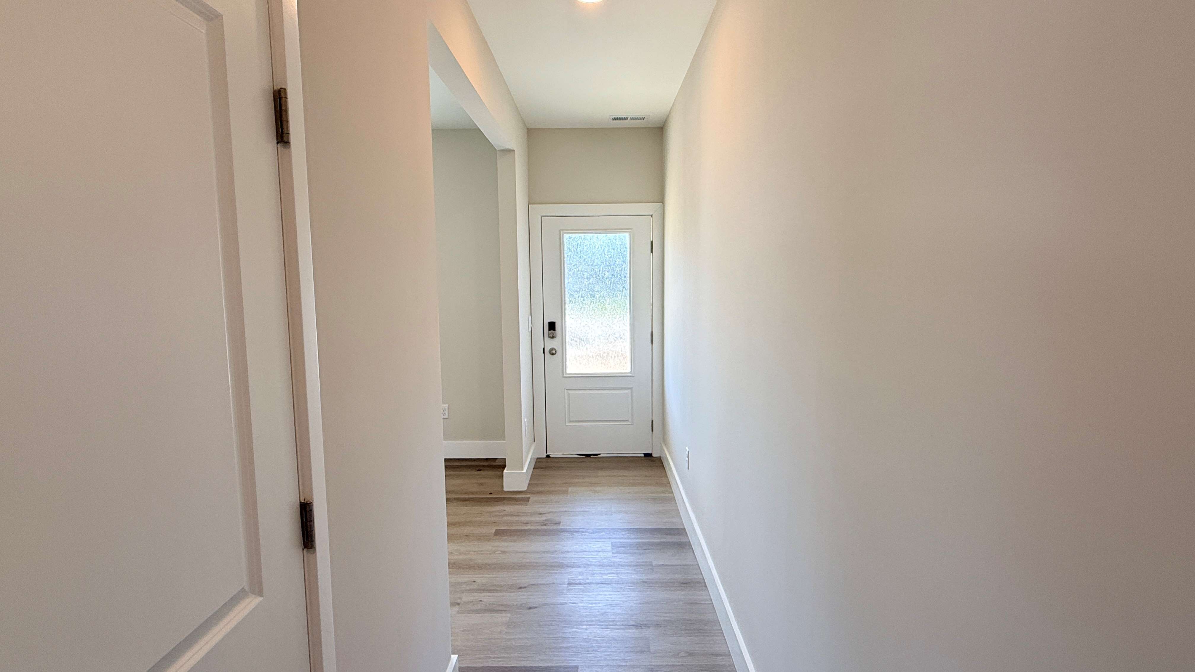 Foyer with luxury vinyl plank flooring.