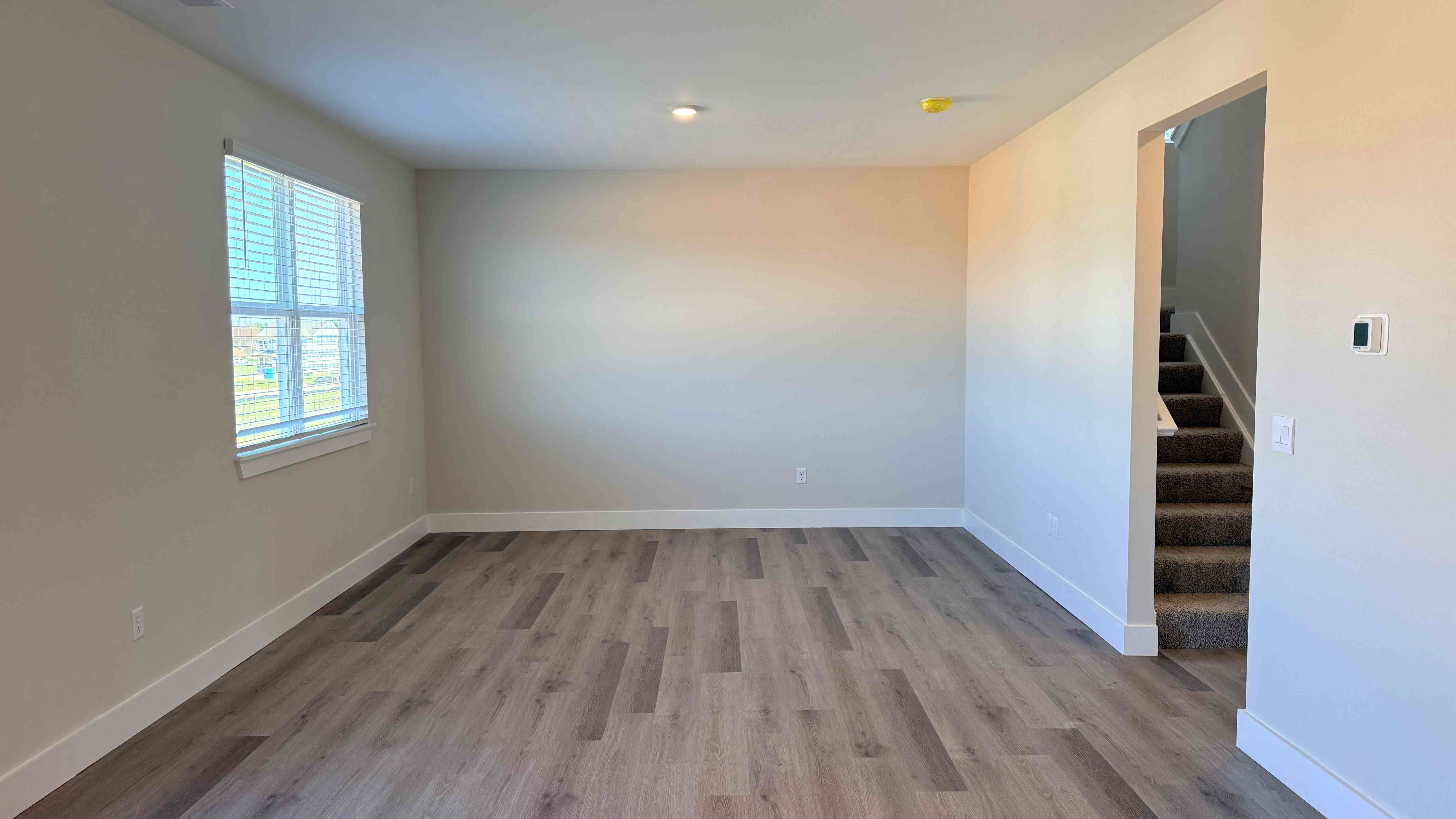 Living room with double window and luxury vinyl plank flooring.