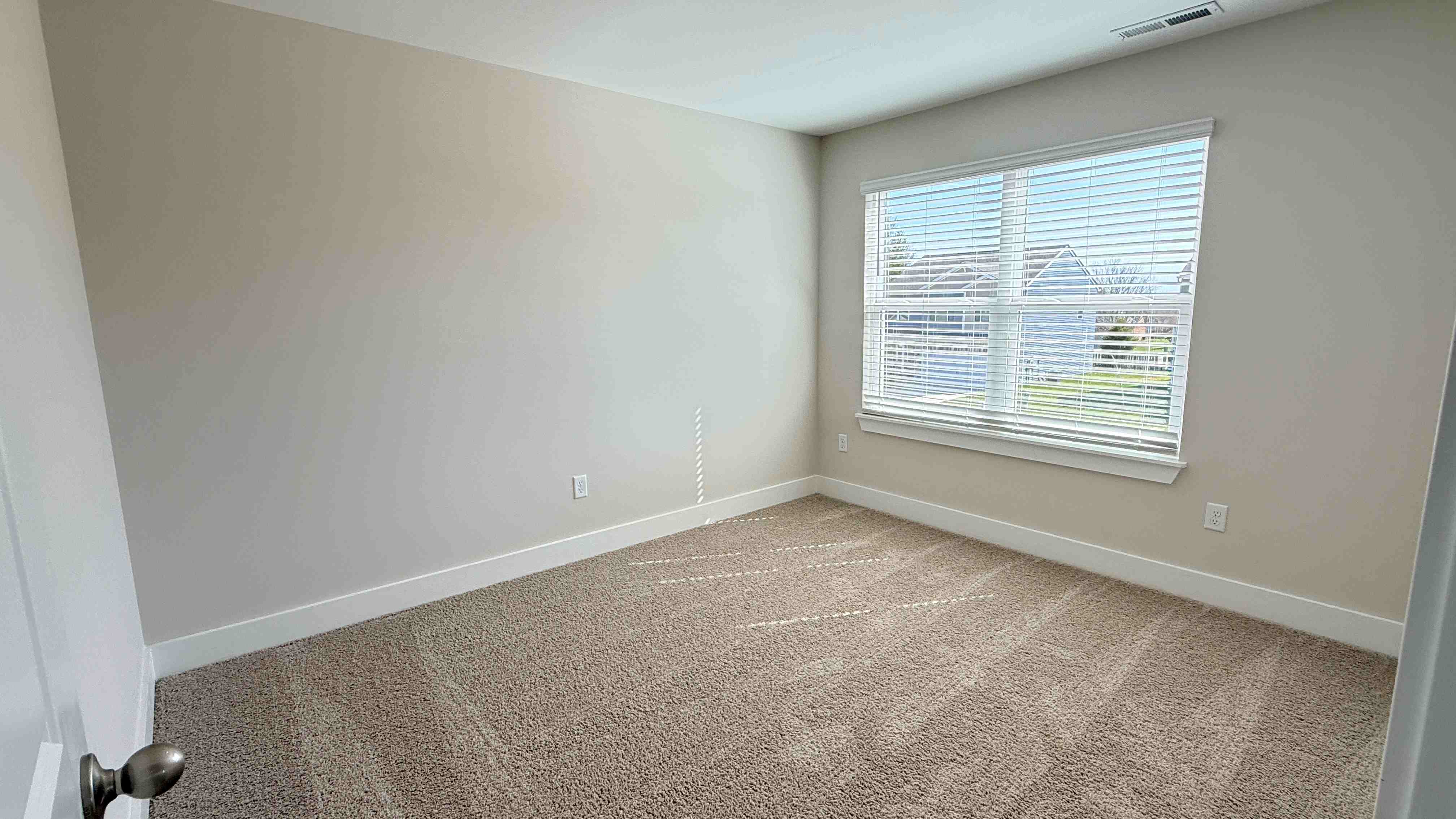 Upstairs spare bedroom with double window.