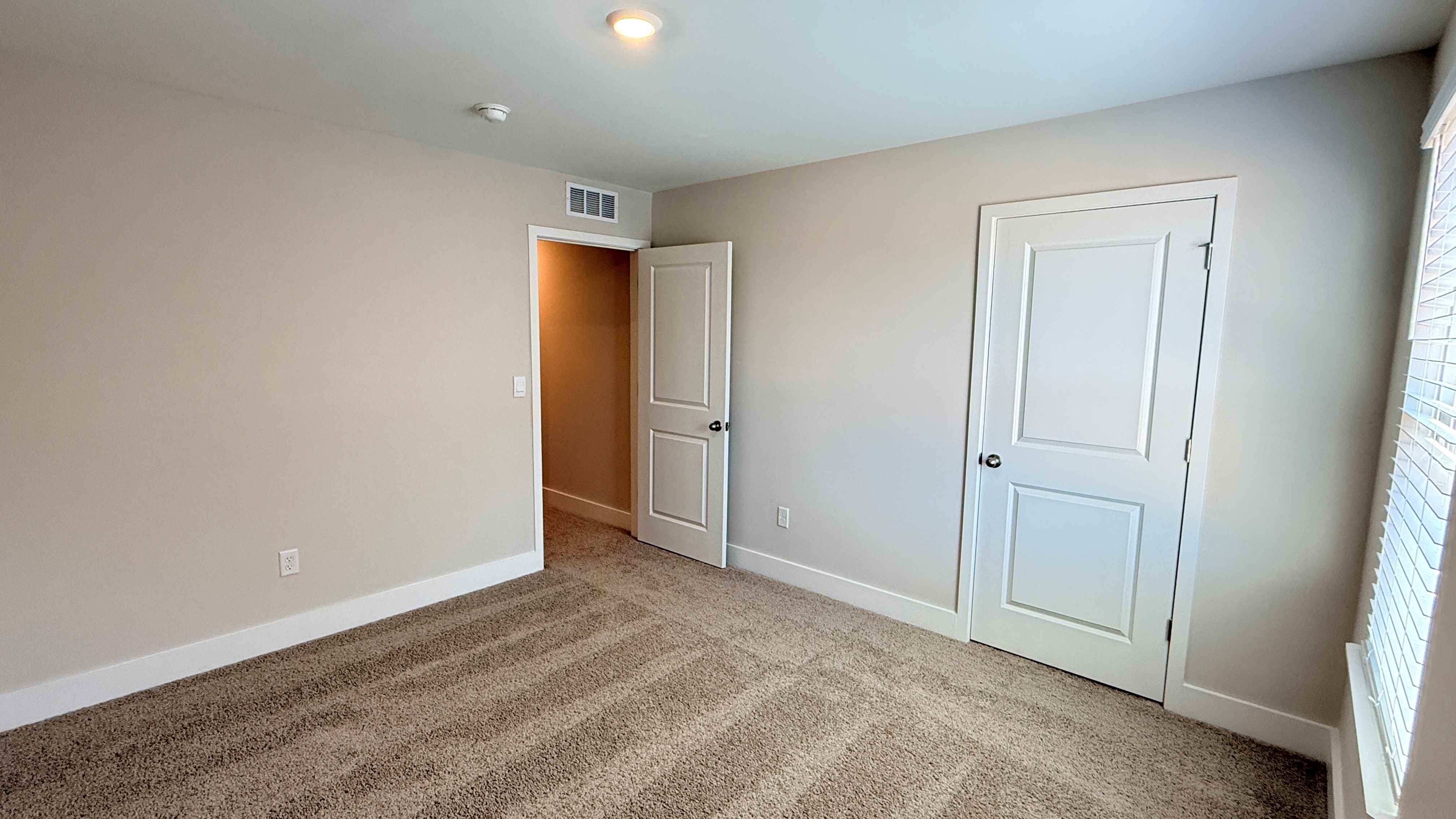 Other view of spare bedroom with closet door.
