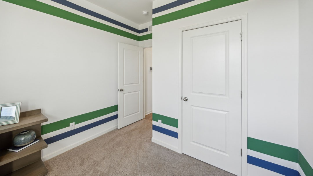 home office feature a corner desk, decorated with blue and green stripes on the wall
