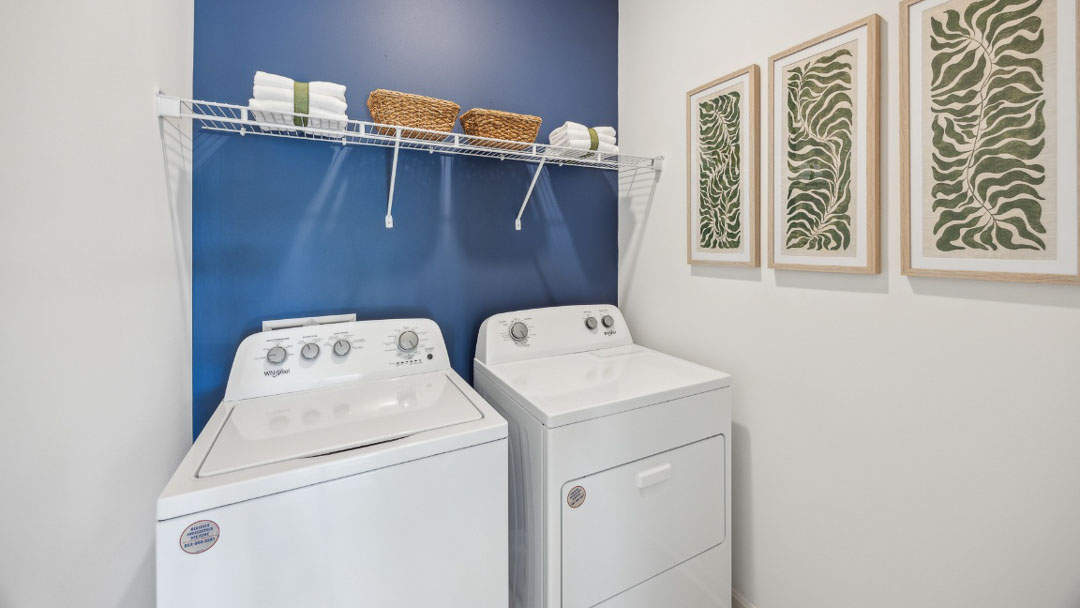spacious laundry room with side by side washer and dryer