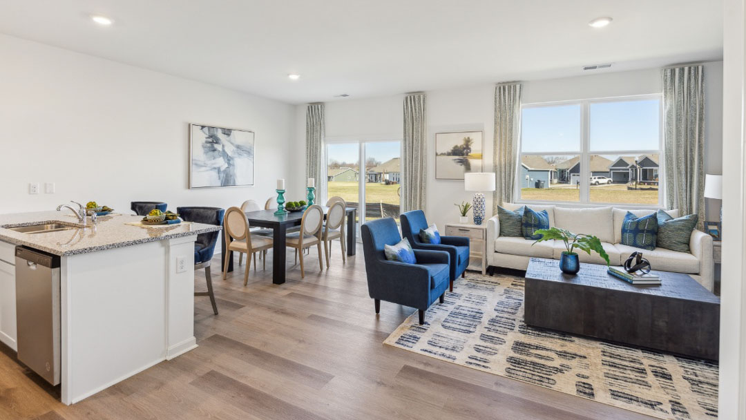 open concept living area featuring the kitchen, living room and dining room all next to each other