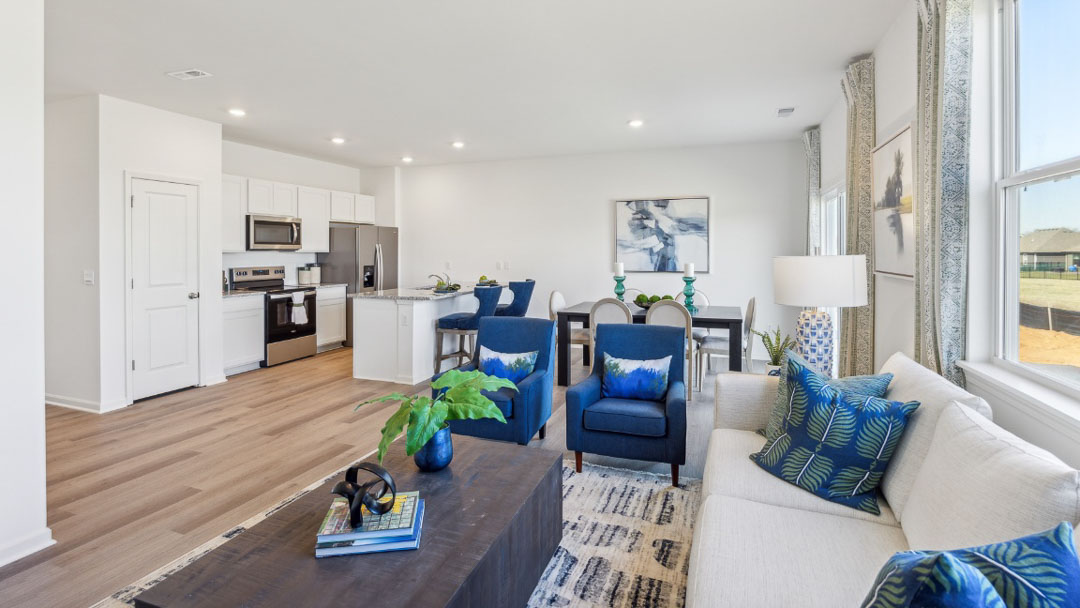 open concept living area featuring the kitchen, living room and dining room all next to each other