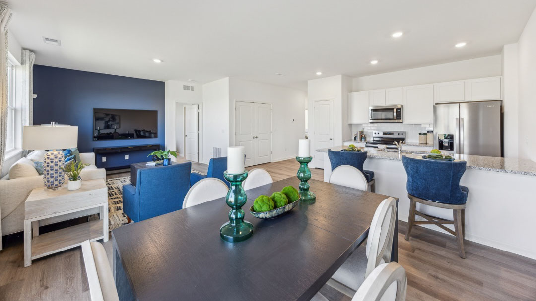 open concept living area featuring the kitchen, living room and dining room all next to each other