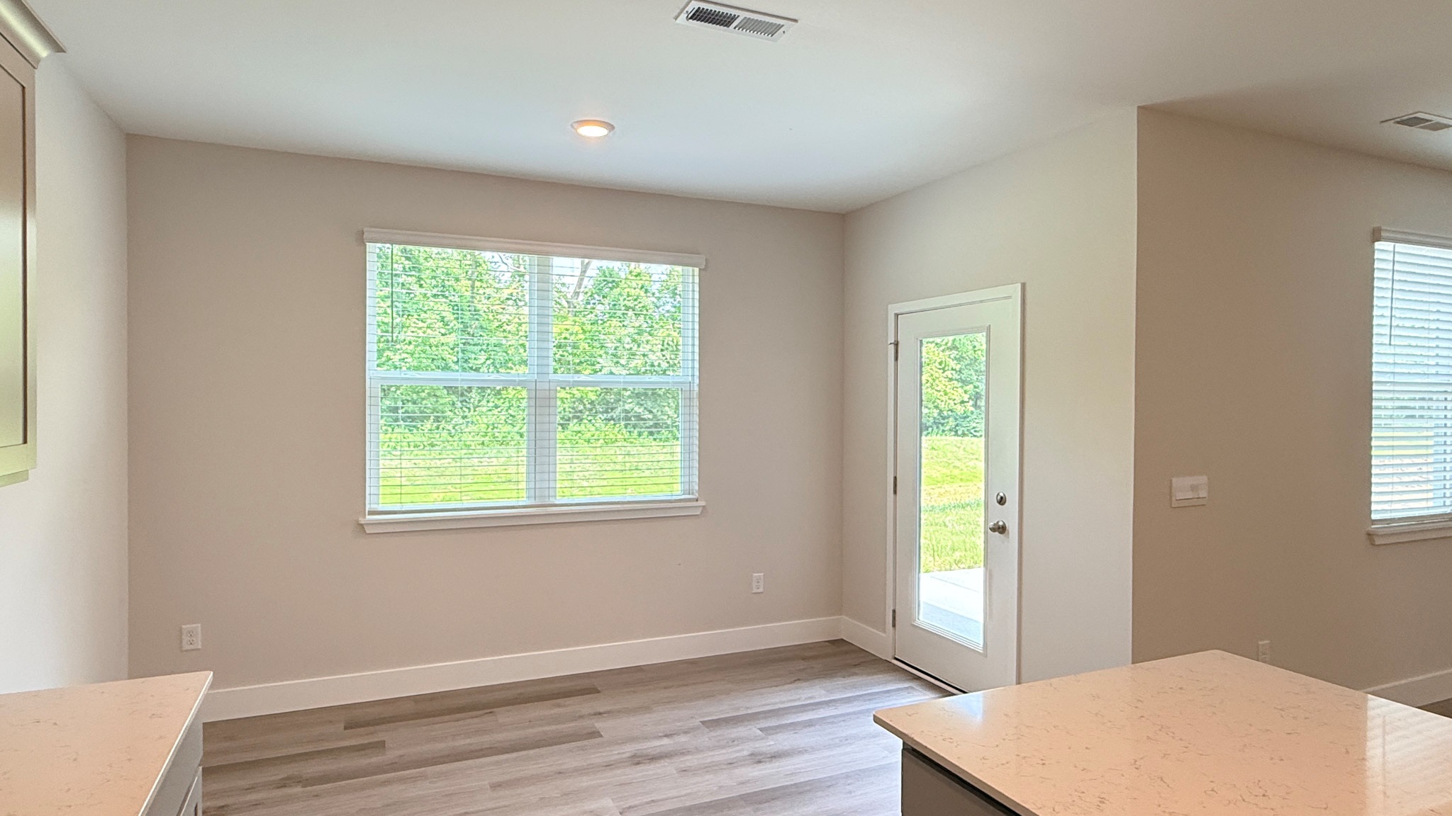 Dining area with a double window overlooking the backyard.