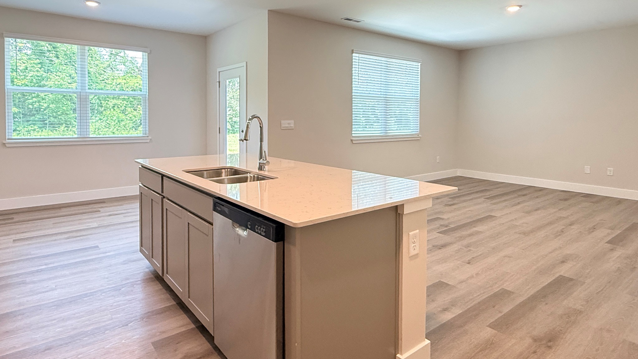 Kitchen island with quartz countertoops overlooking the living room and dining area.