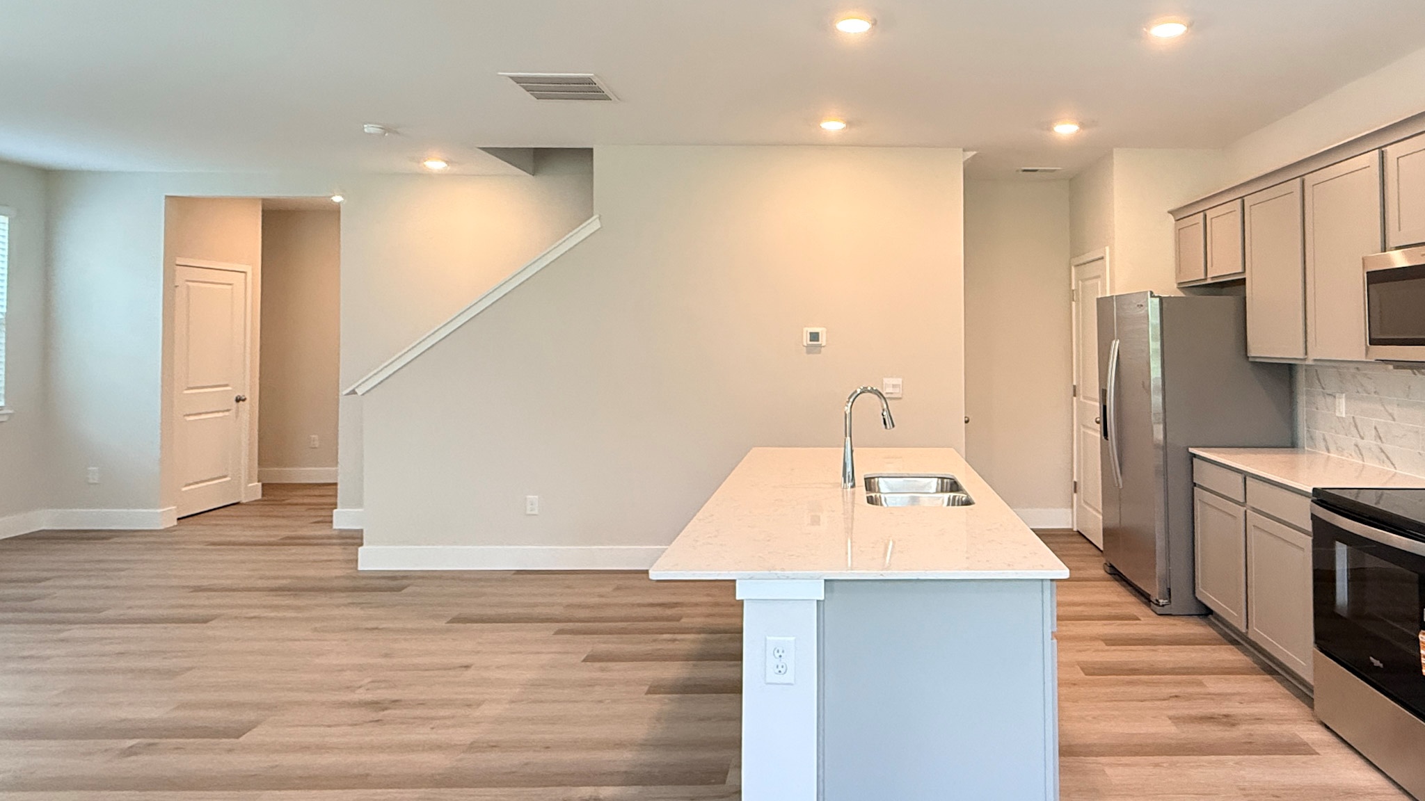 Kitchen island with quartz countertops overlooking the living room.