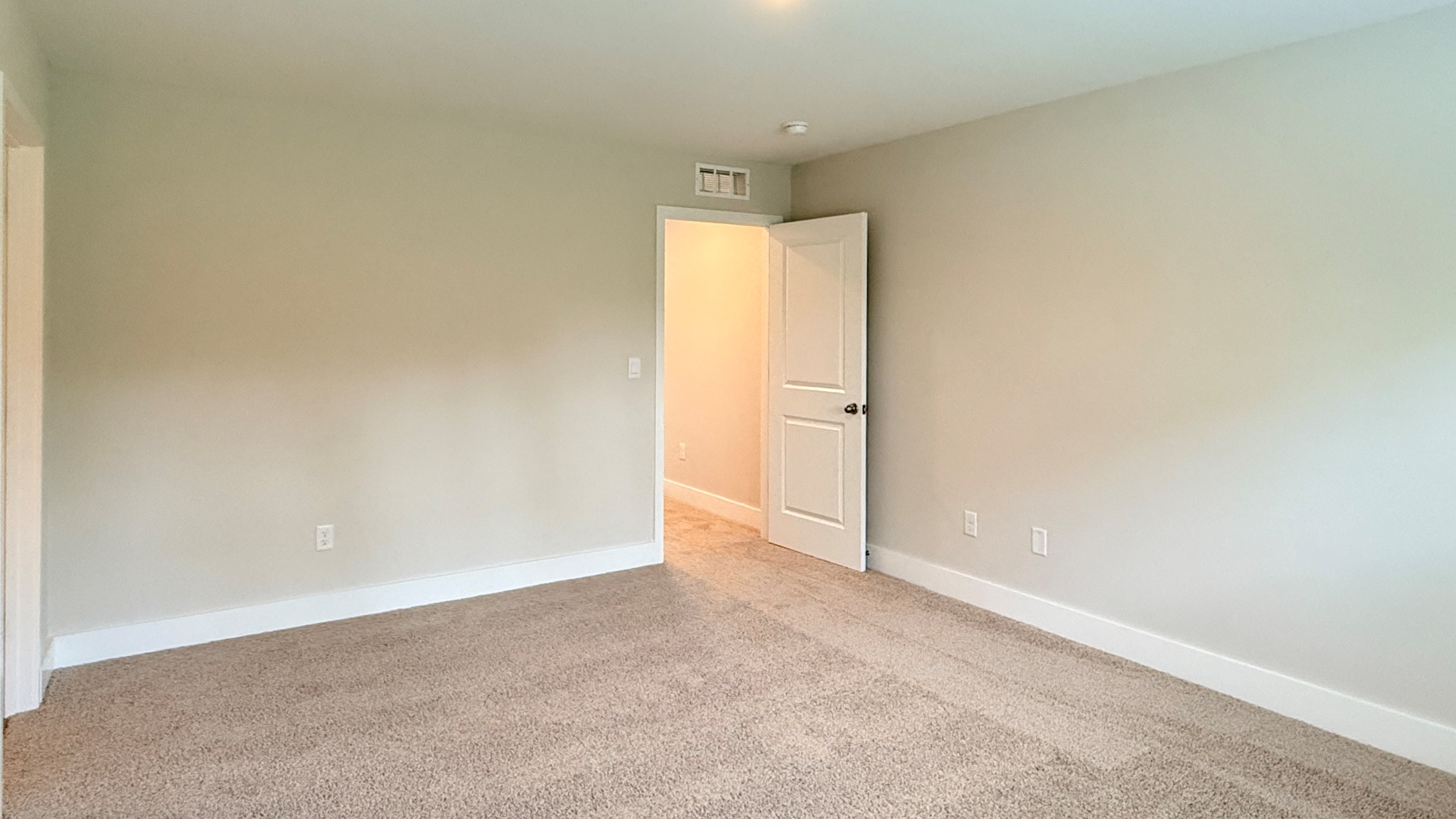 Primary bedroom with carpet