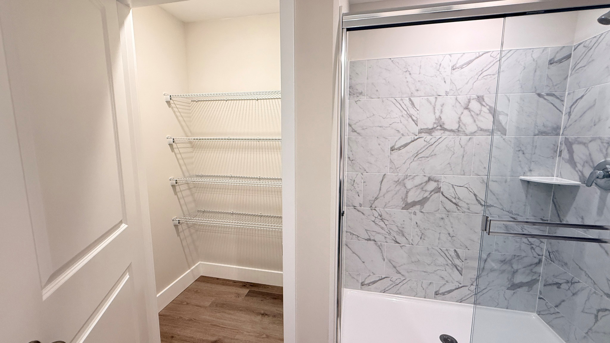 Large linen closet in the primary bathroom and a tiled shower.