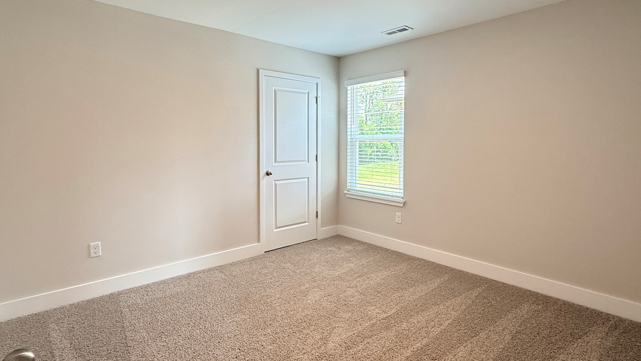 Spare bedroom with a single window and closet